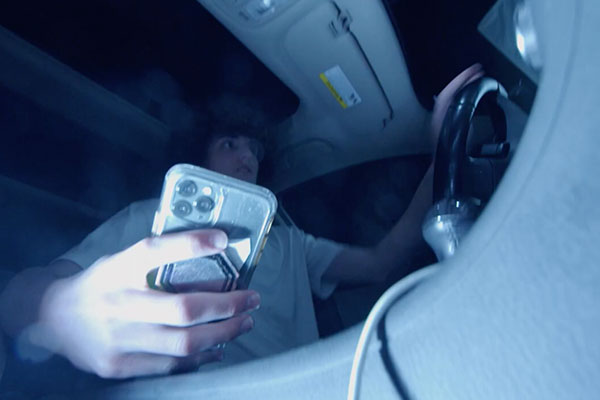 male driver playing with his phone whole driving