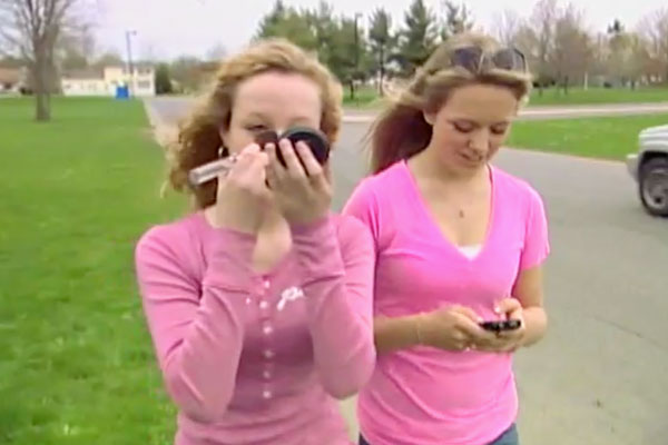 two girls walking distracted