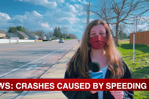 news cast with woman wearing a mask