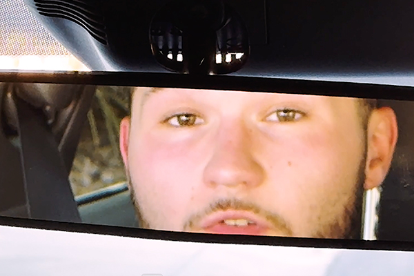 male driver in the rear view mirror