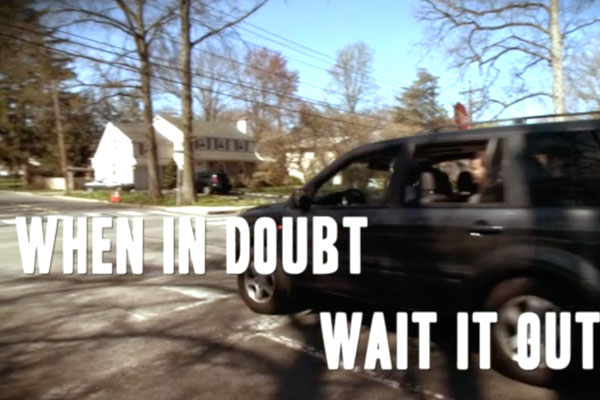 a car on road with the chyron - when in doubt wait it out
