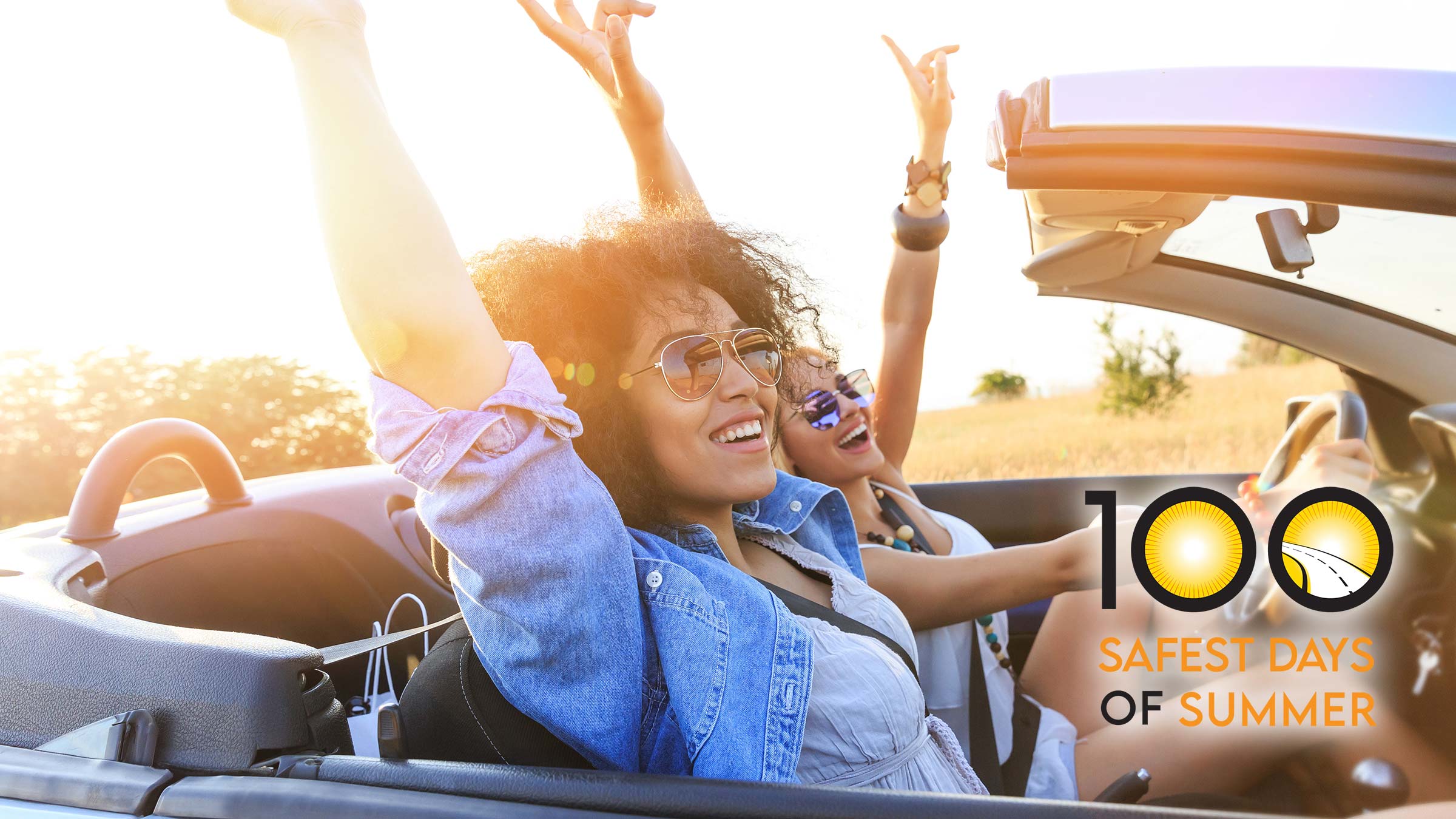 two teen women driving in a convertable
