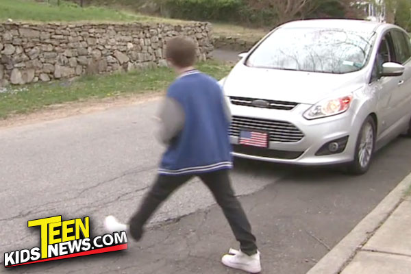 kid walking across the street with a car coming