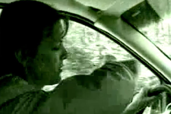 a woman driving looking at her watch